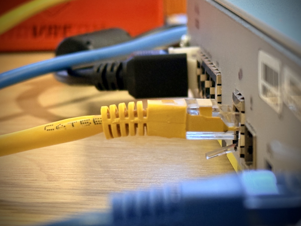 Close-up of networking cables connected to a switch during automated ITAD testing with Hydra